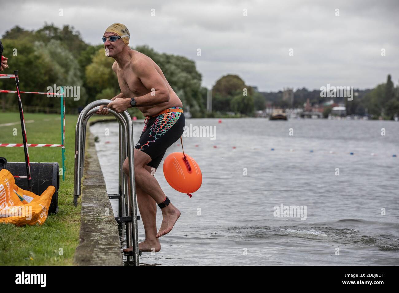 Swimmers take part in the annual Henley Swimming Festival where they swim in the River Thames in the ‘Henley Classic’ and varied lengths of miles. Stock Photo