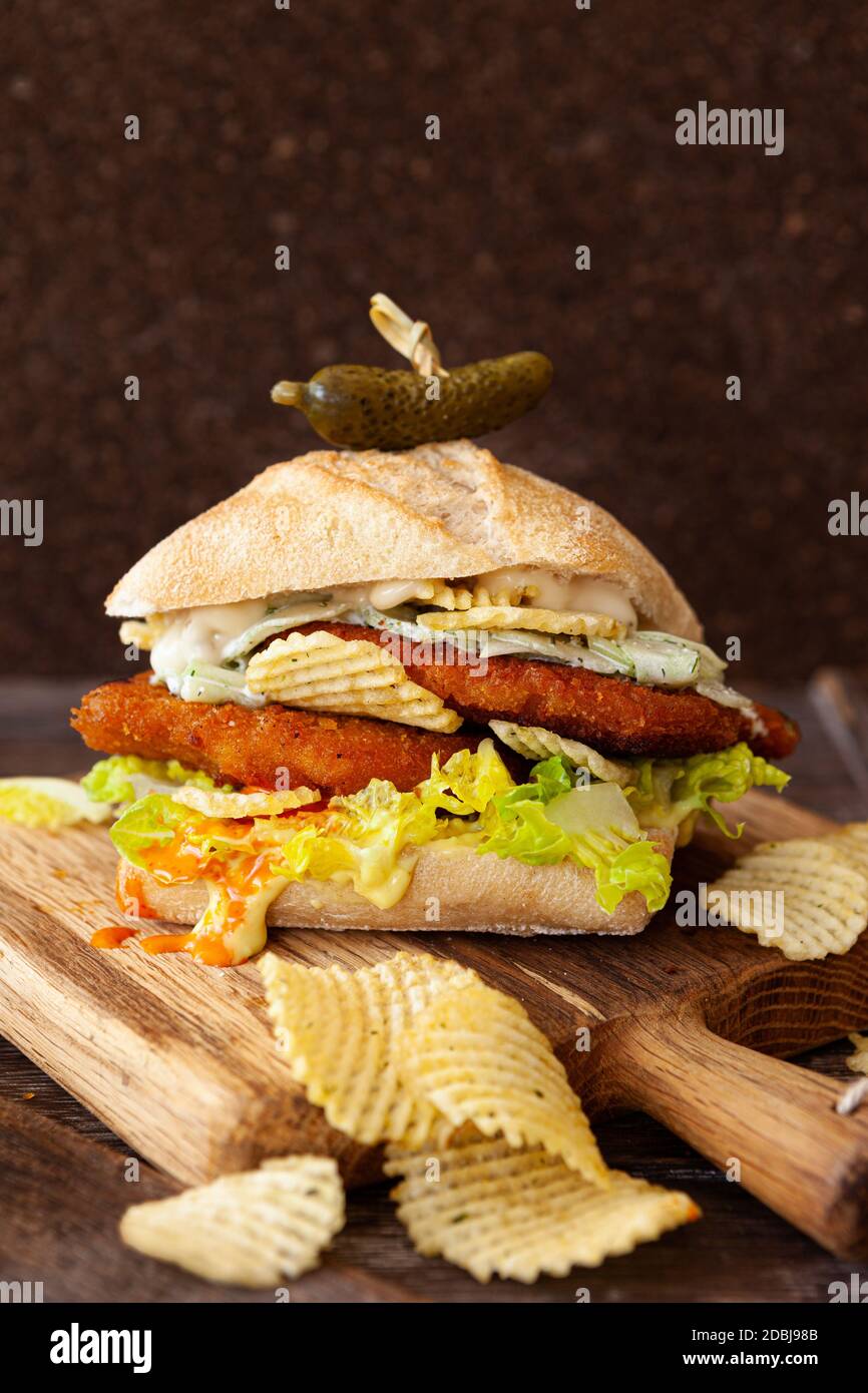 Over stuffed chicken sandwich and sour cream chips Stock Photo