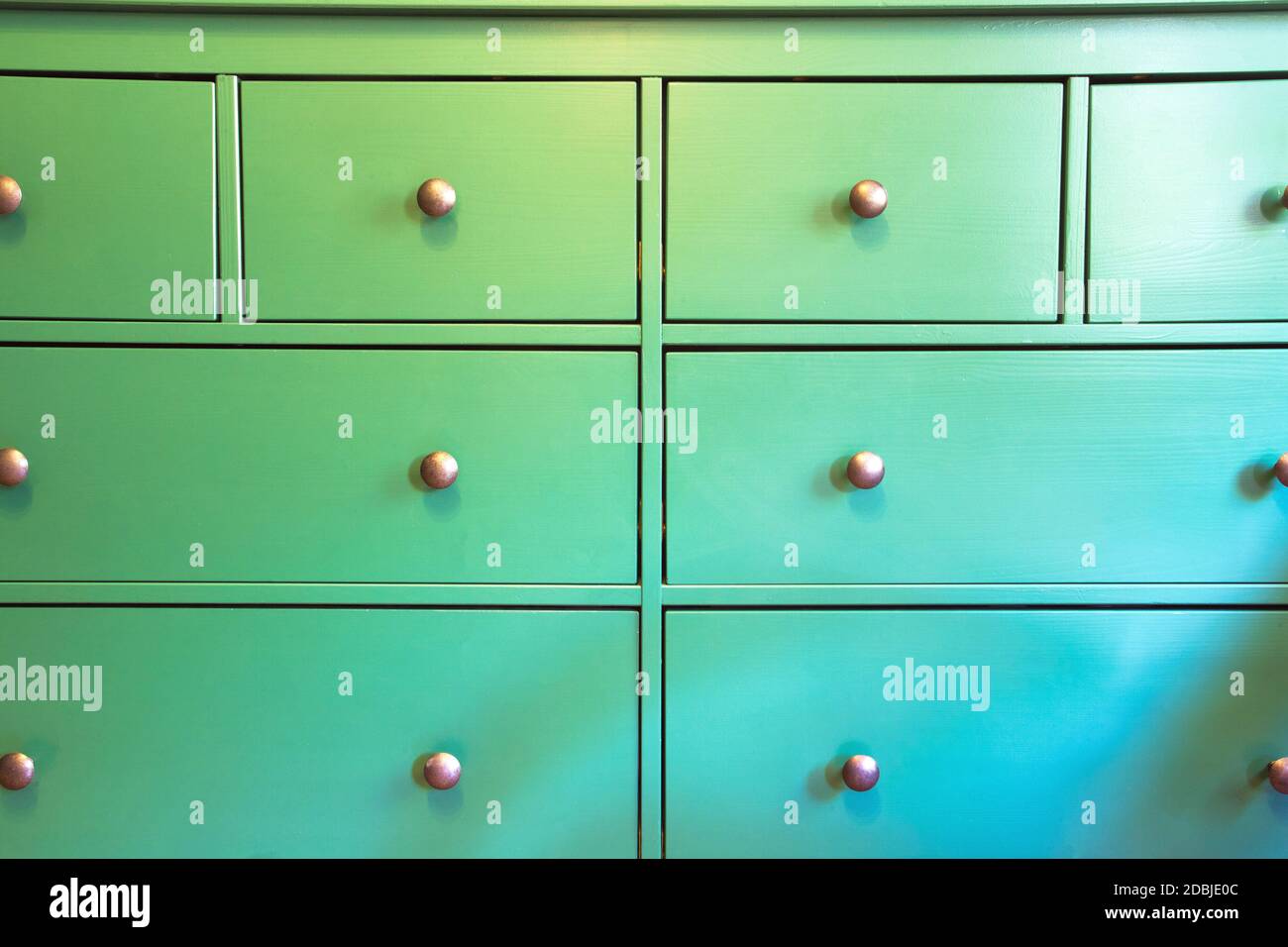 Green with various drawers, colorful wooden closet closeup