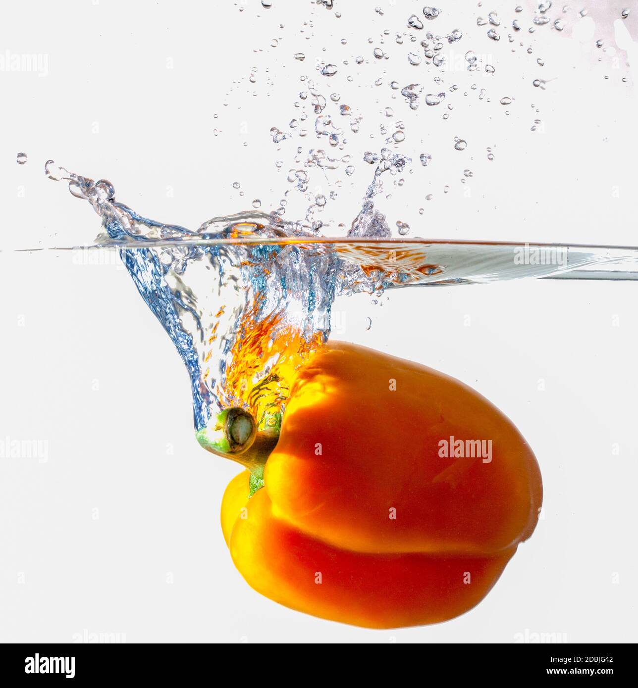 Orange Bell Pepper Dropping Into Water Stock Photo Alamy