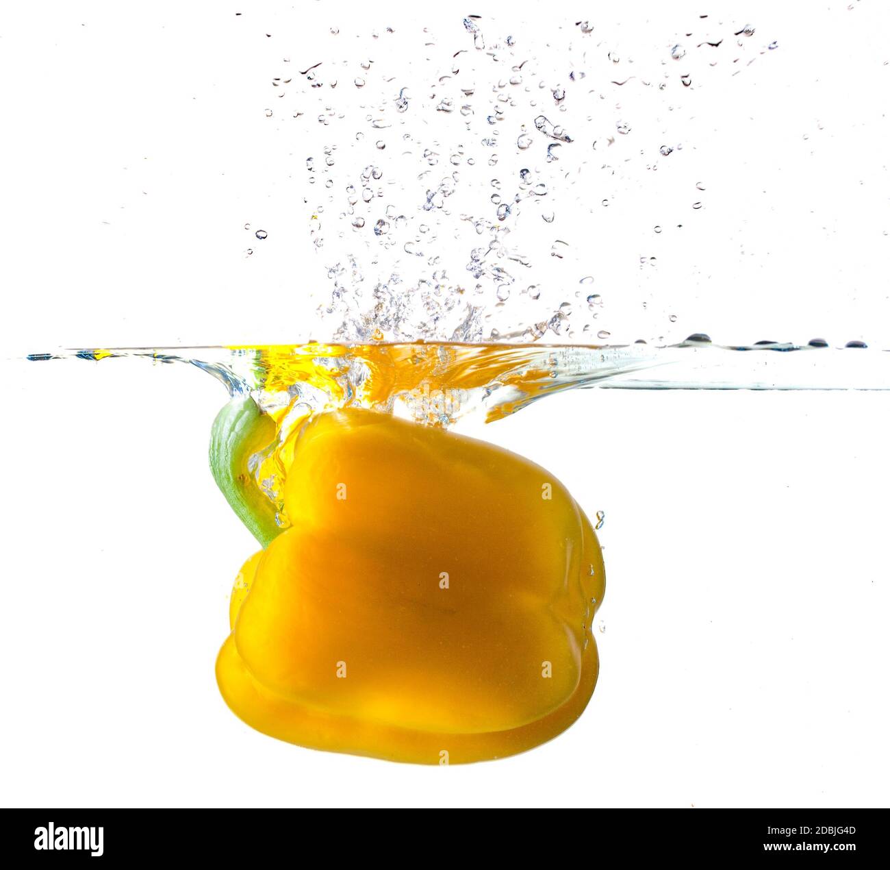 Yellow Bell Pepper Dropping Into Water Stock Photo Alamy