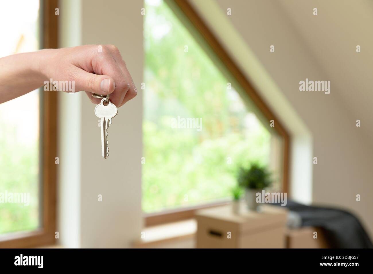 Move. Cardboard boxes for moving into a new, clean home. In a sunny day by a window in attic. Stock Photo