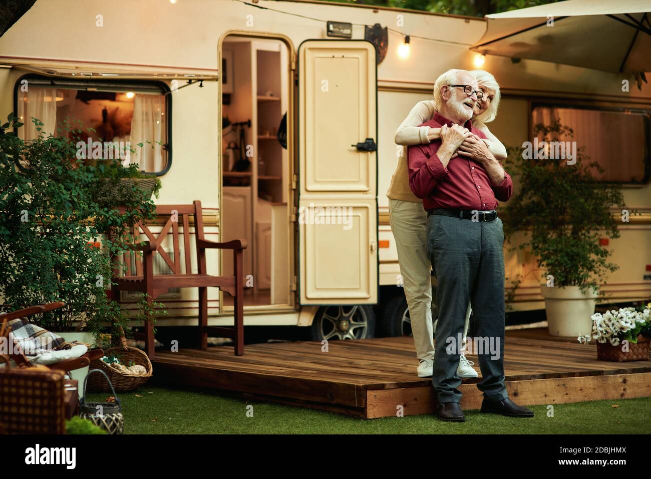 Full Length Photo Of Smiling Elderly Married Couple Hugging While