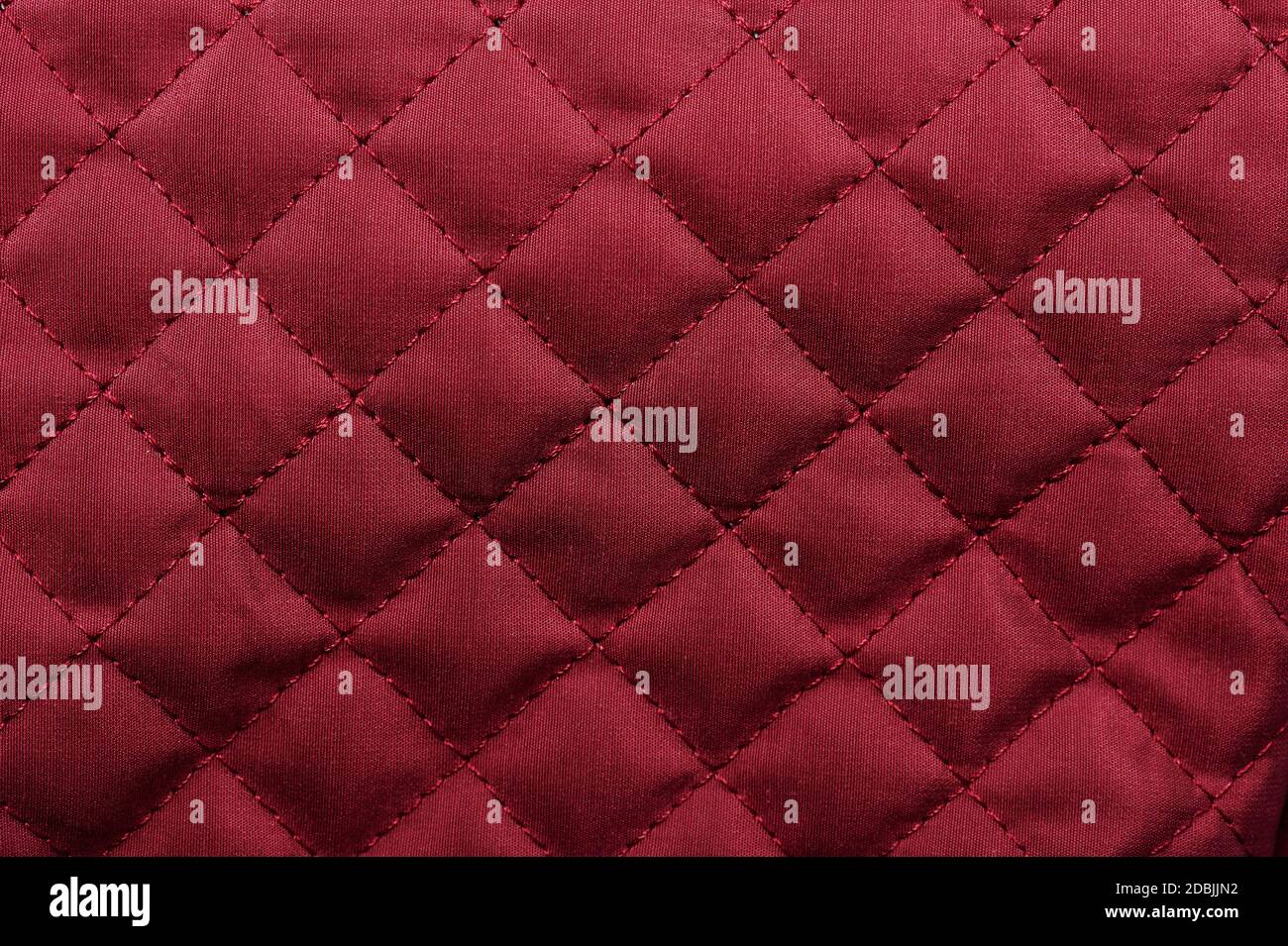 Red luxury tufted fabric texture background with stitches Stock Photo