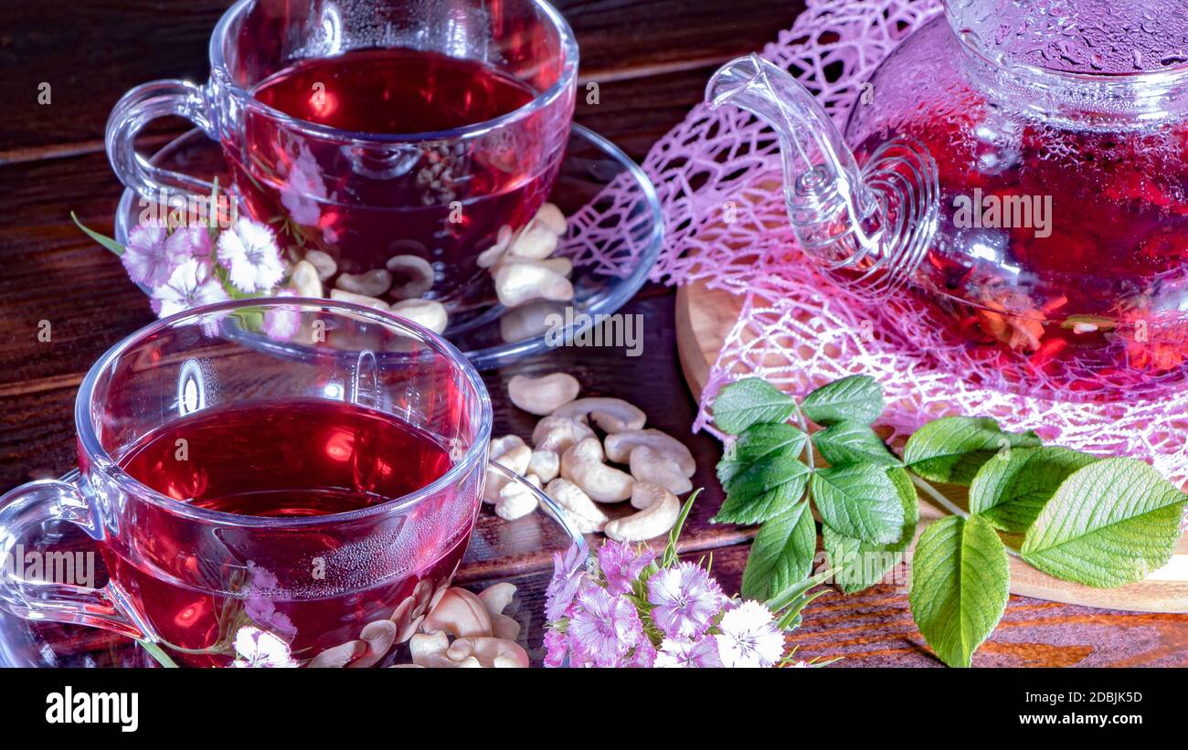 Mugs of red tea with carnation flowers. Zen tea ceremony. English tea