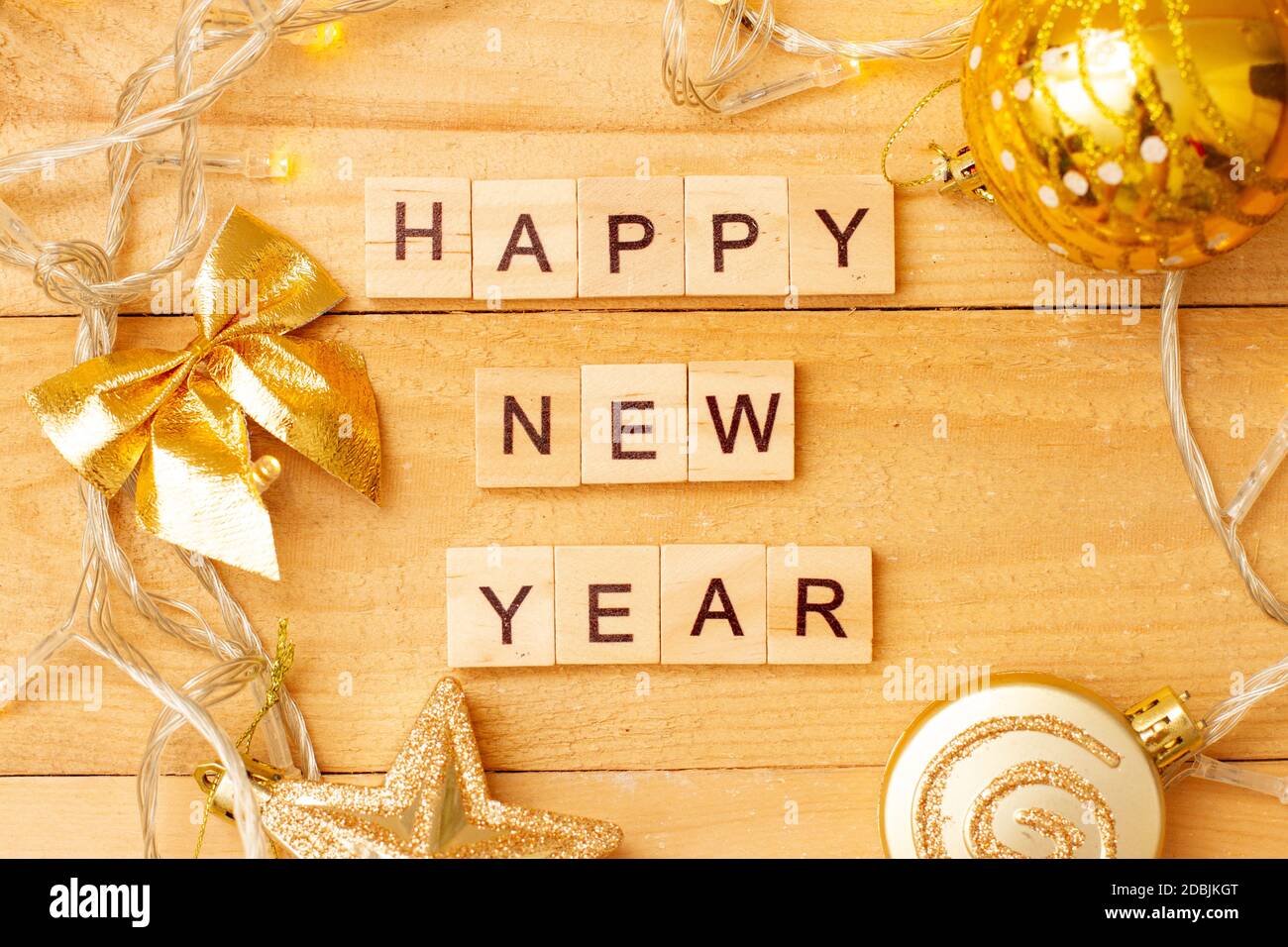 Word HAPPY NEW YEAR made from wooden cubes with decoration for Chistmas. Banner, backdrop. Stock Photo