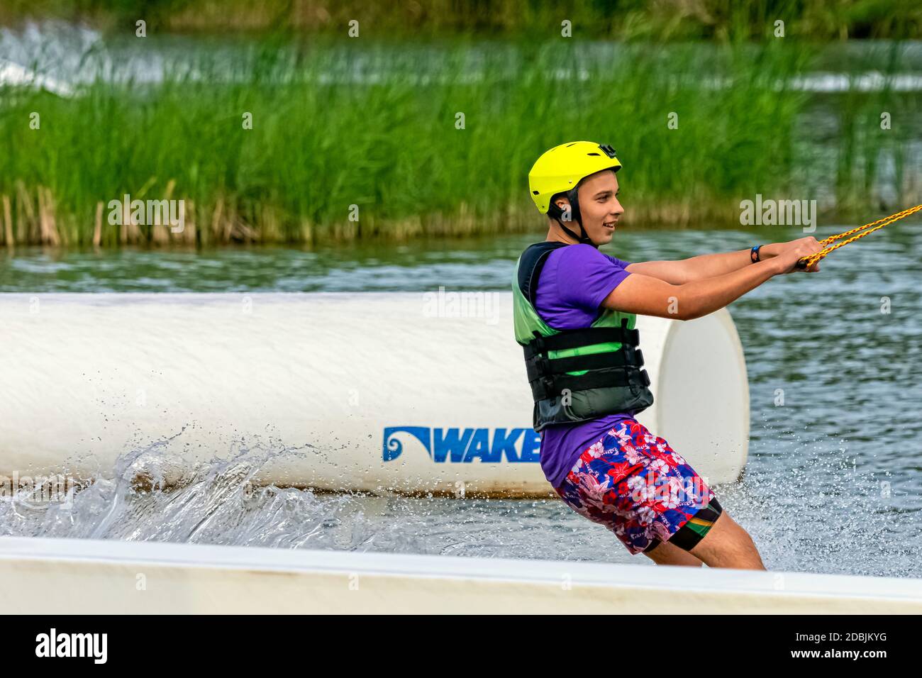 Teenager wakeboarding on a lake - Brwinow, Masovia, Poland Stock Photo