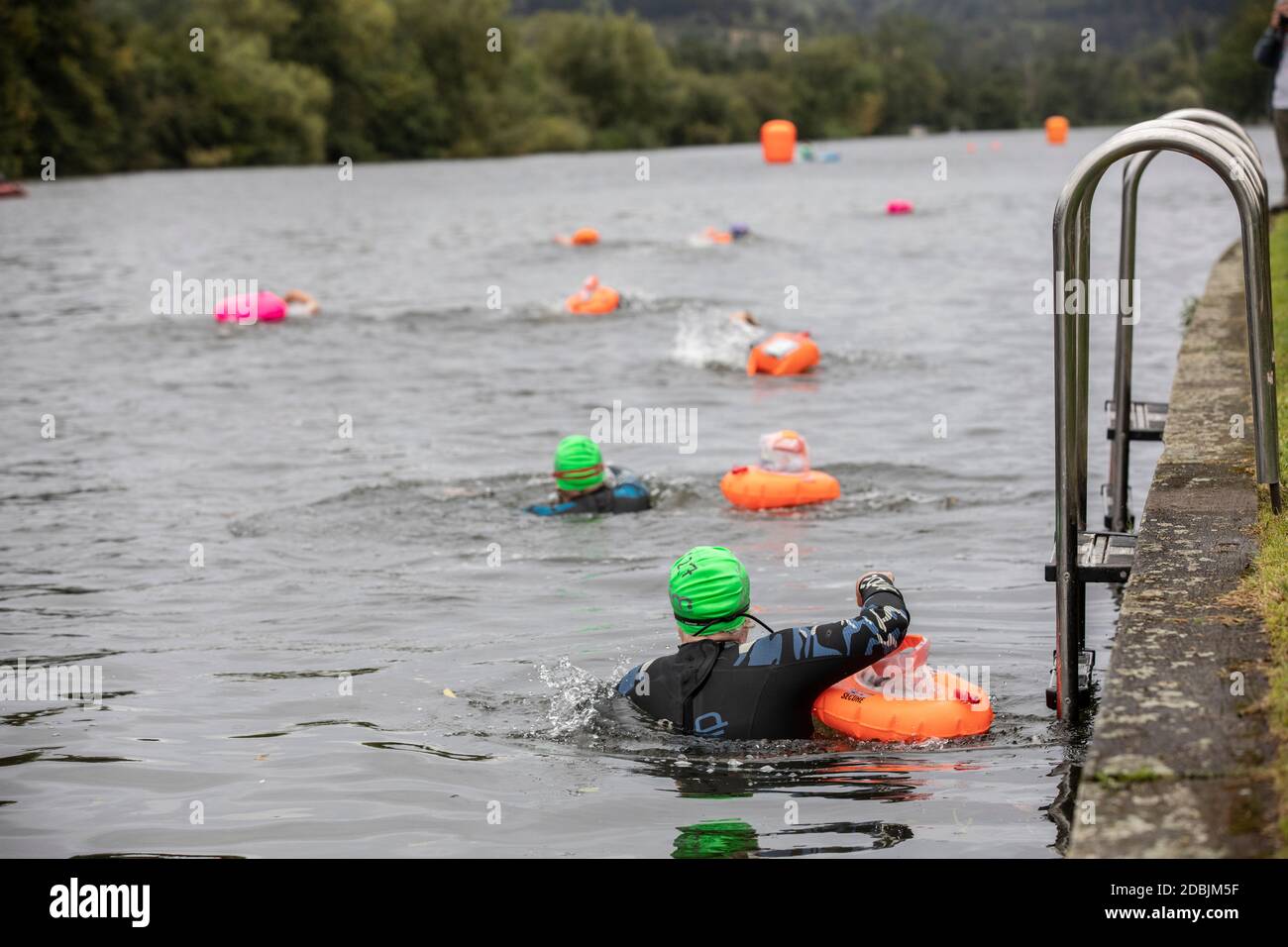 Swimmers take part in the annual Henley Swimming Festival where they swim in the River Thames in the ‘Henley Classic’ and varied lengths of miles. Stock Photo