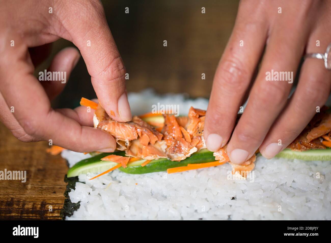 Kimi Werner prepares salmon sushi. Stock Photo