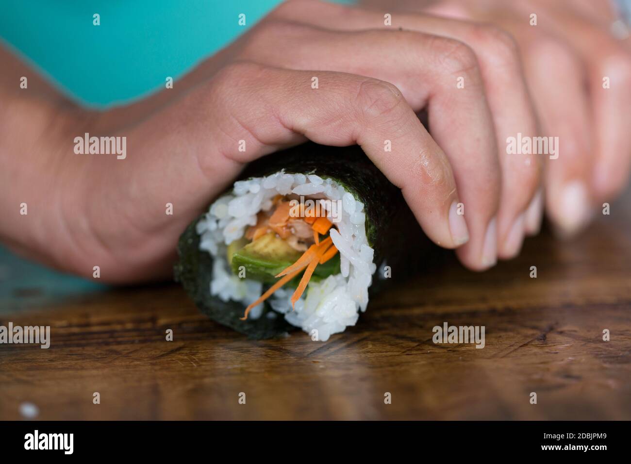 Kimi Werner prepares salmon sushi. Stock Photo