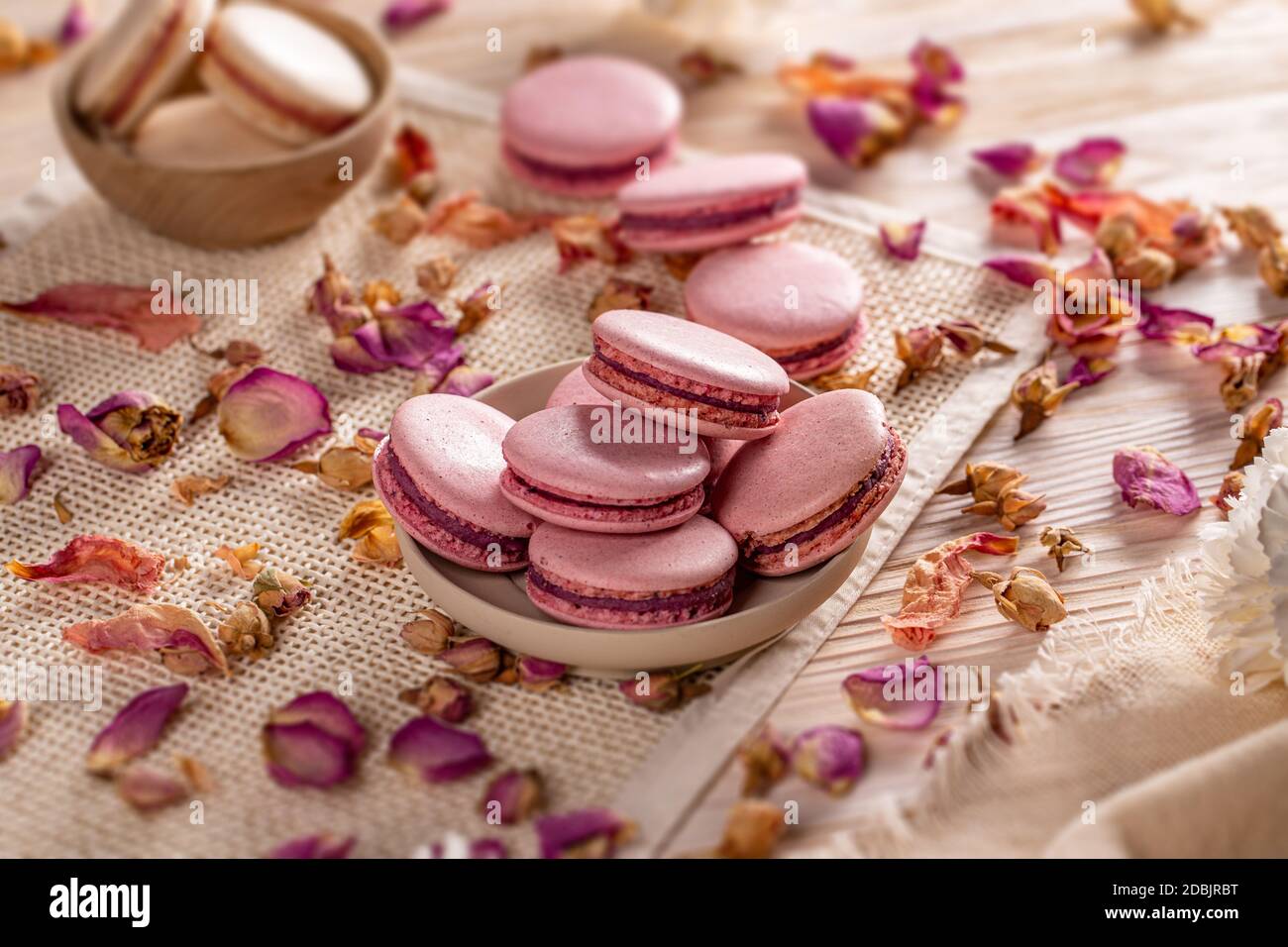 Small glass milk bottle with pink candy stripe paper straws and pink  macarons Stock Photo - Alamy