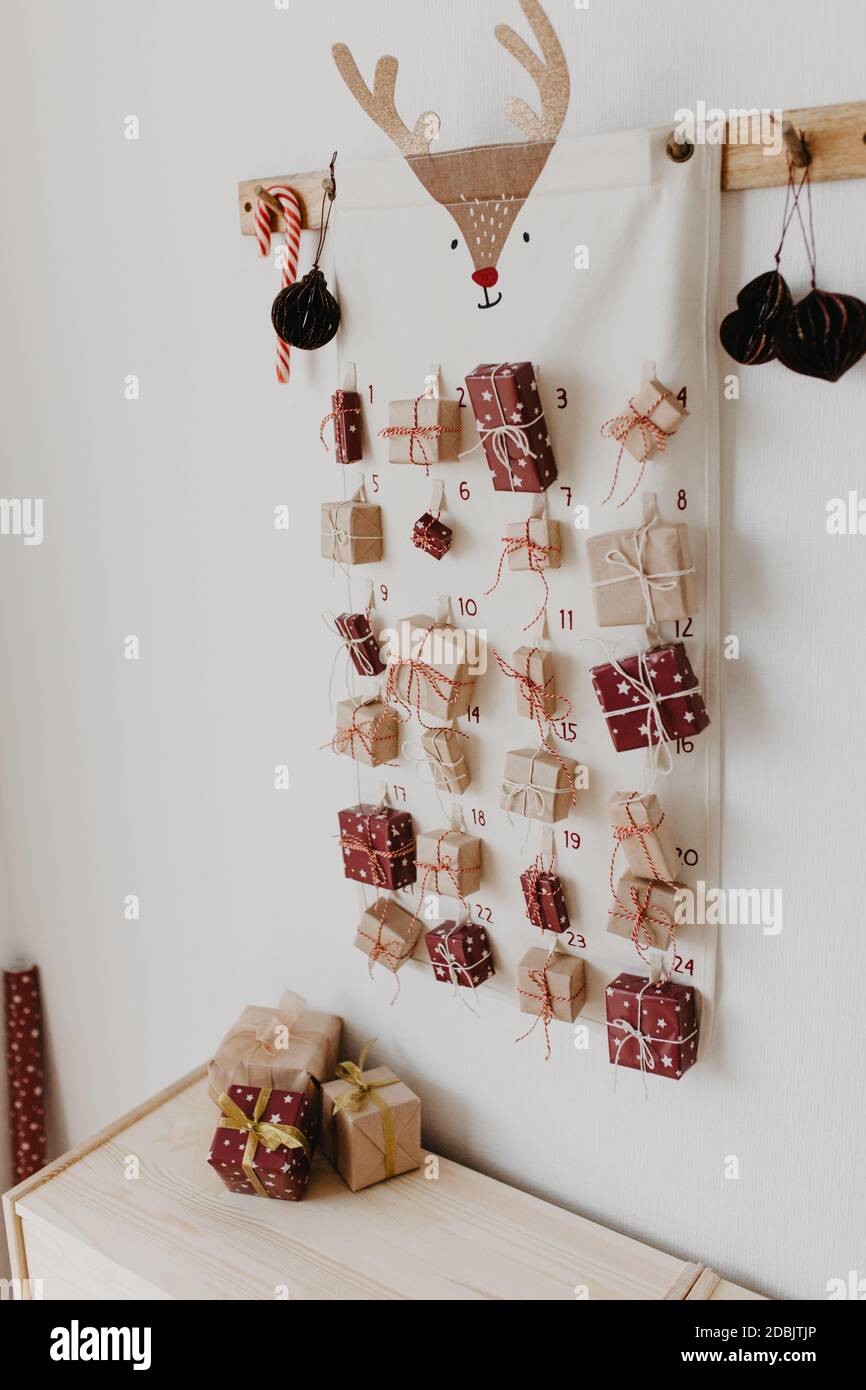 Christmas Advent calendar hanging on the wall. Wrapped gifts for