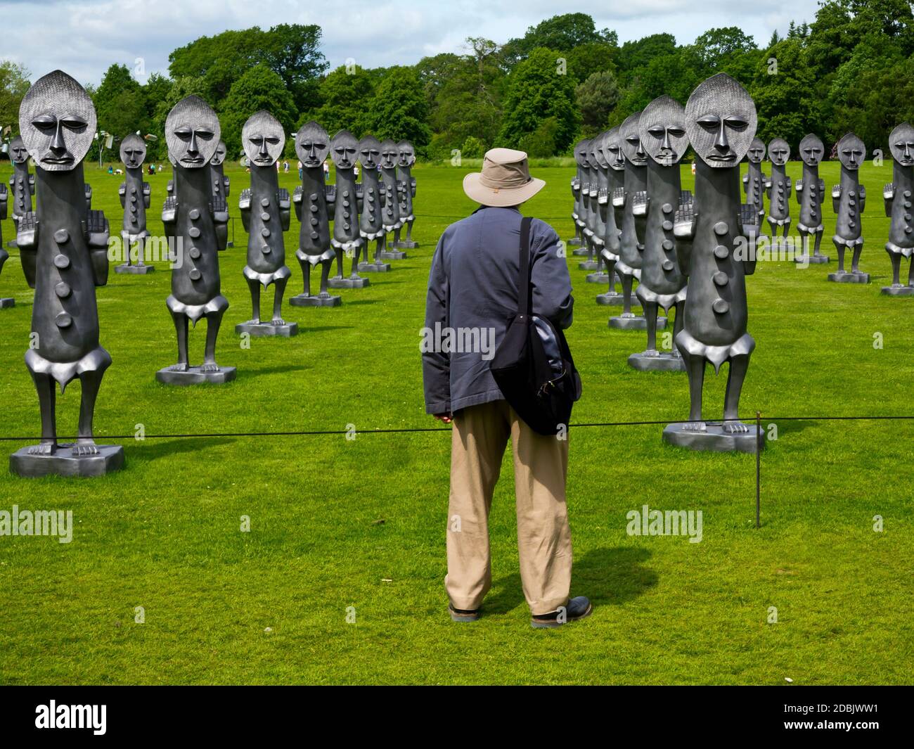 Visitor at the Yorkshire Sculpture Park Wakefield England admiring Black and Blue The Invisible Men and the Masque of Blackness by Zak Ove in 2017 Stock Photo