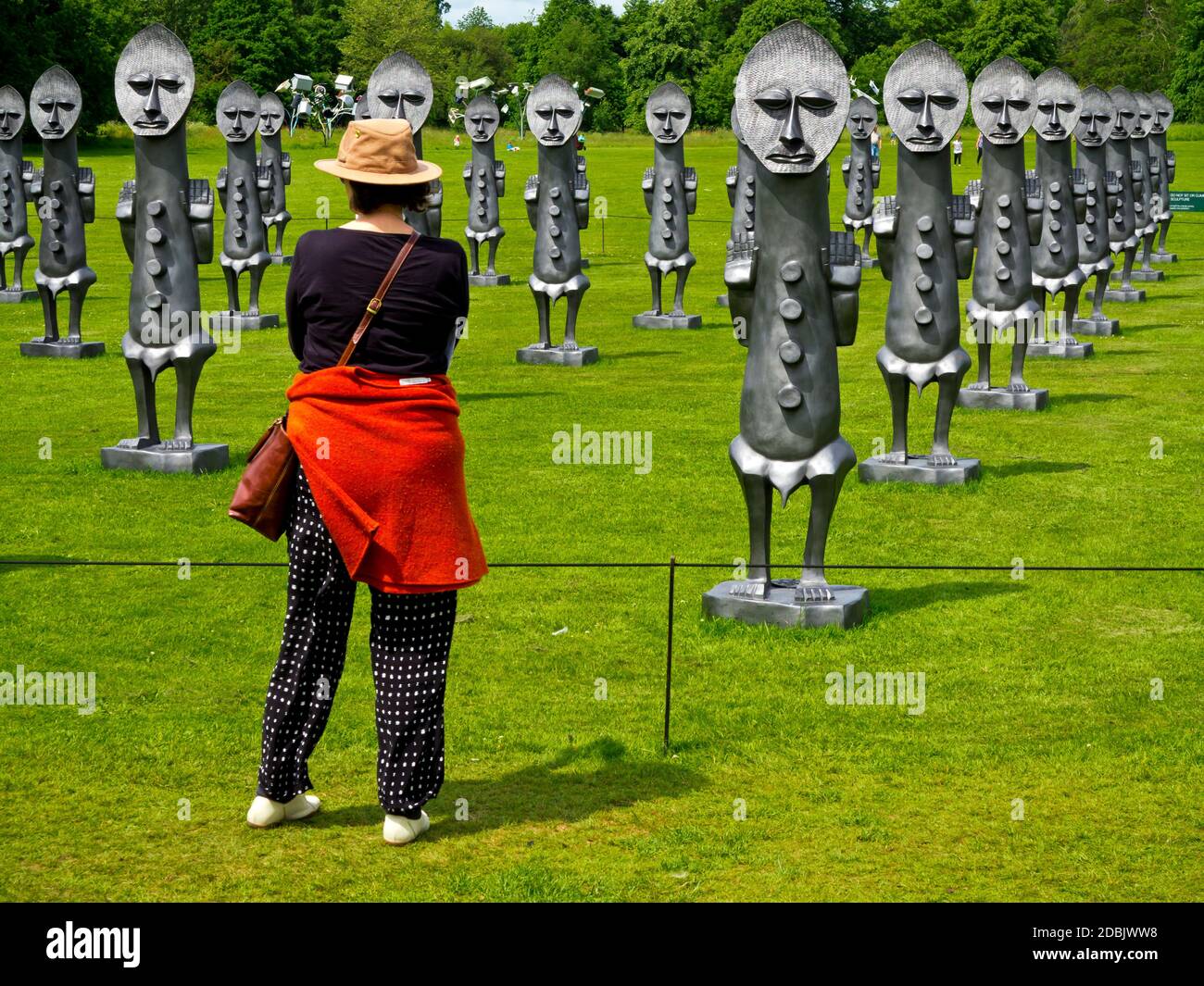 Visitor at the Yorkshire Sculpture Park Wakefield England admiring Black and Blue The Invisible Men and the Masque of Blackness by Zak Ove in 2017 Stock Photo