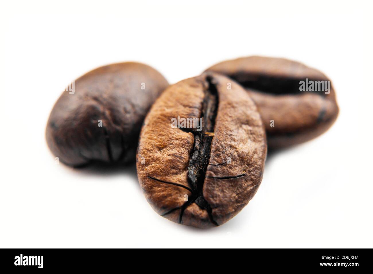 Macro Coffee beans on white background, roasted coffee beans isolated on white background. Close-up roasted coffee beans isolated on white background. Stock Photo