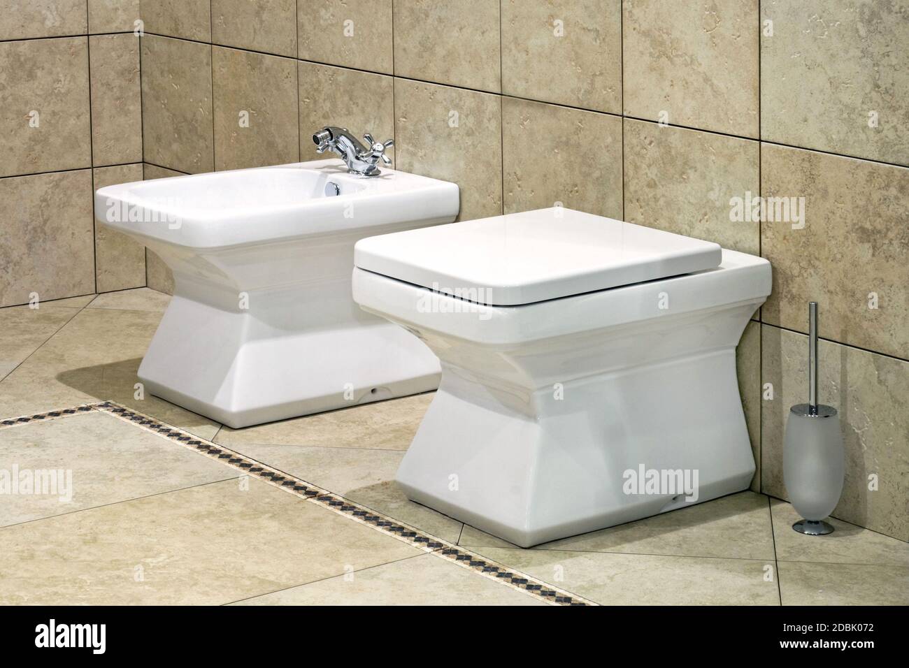 White bidet and toilet in beige lavatory Stock Photo - Alamy