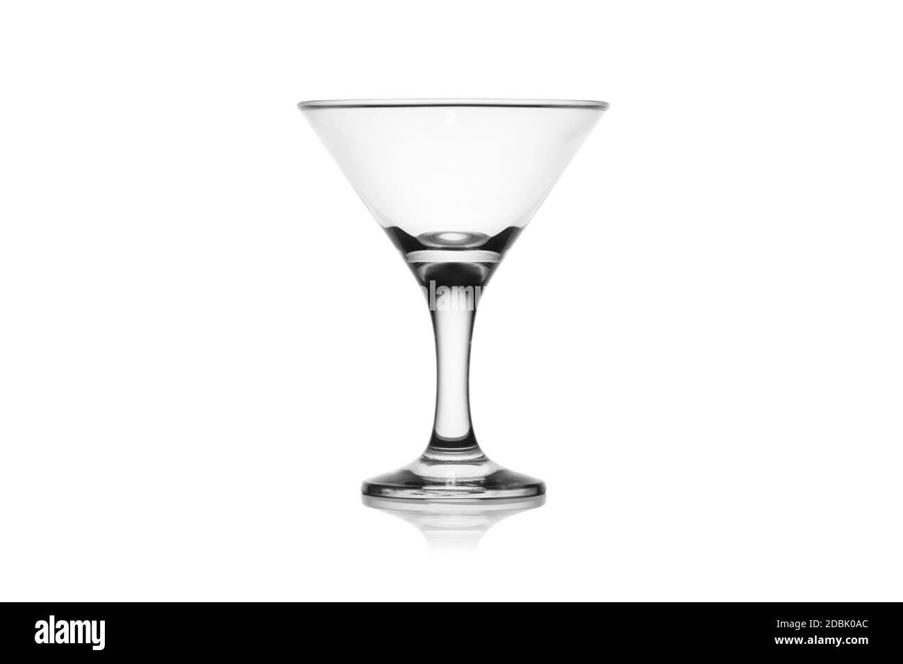 Empty martini glass isolated on a white background without glare. Reflection on the surface. Back light. Stock Photo