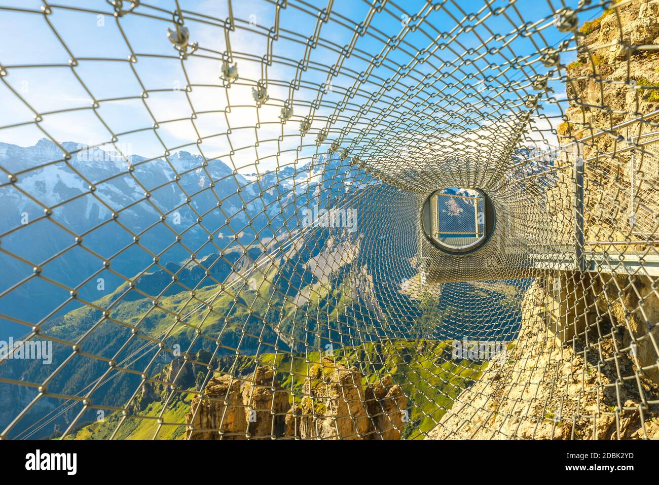 Adrenaline attraction at the edge of steep cliff in Birg, Switzerland. Tube made of nets of Thrill walk on Schilthorn, Canton of Bern. Swiss family Stock Photo