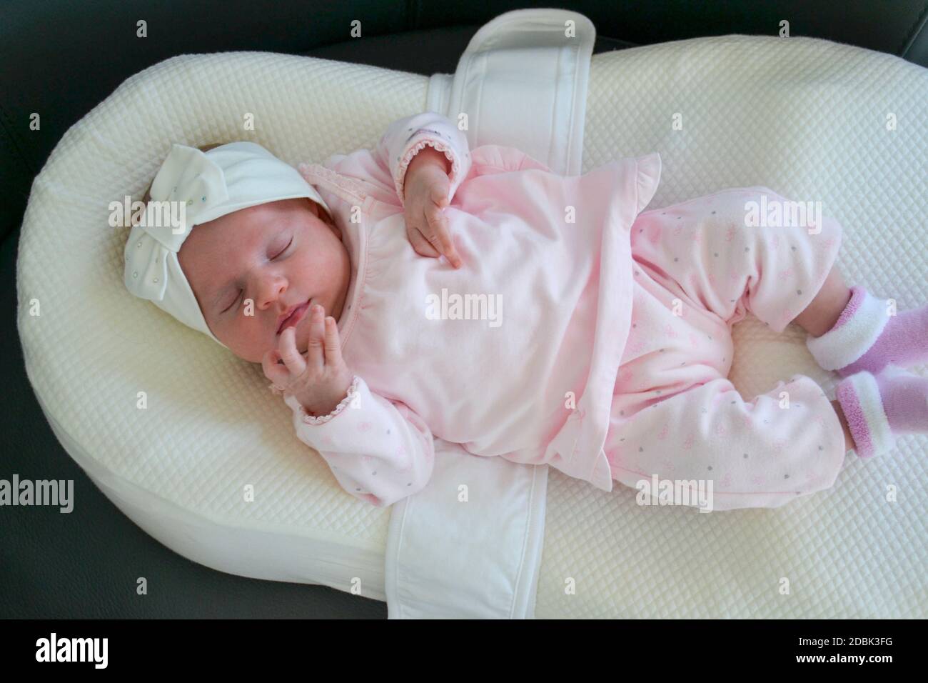 Newborn baby girl in pink dress lies on a special pillow for babies. High  quality photo Stock Photo - Alamy