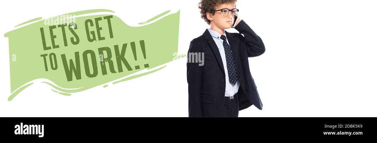 curly boy in suit and glasses talking on smartphone near lets get to work lettering on white, banner Stock Photo