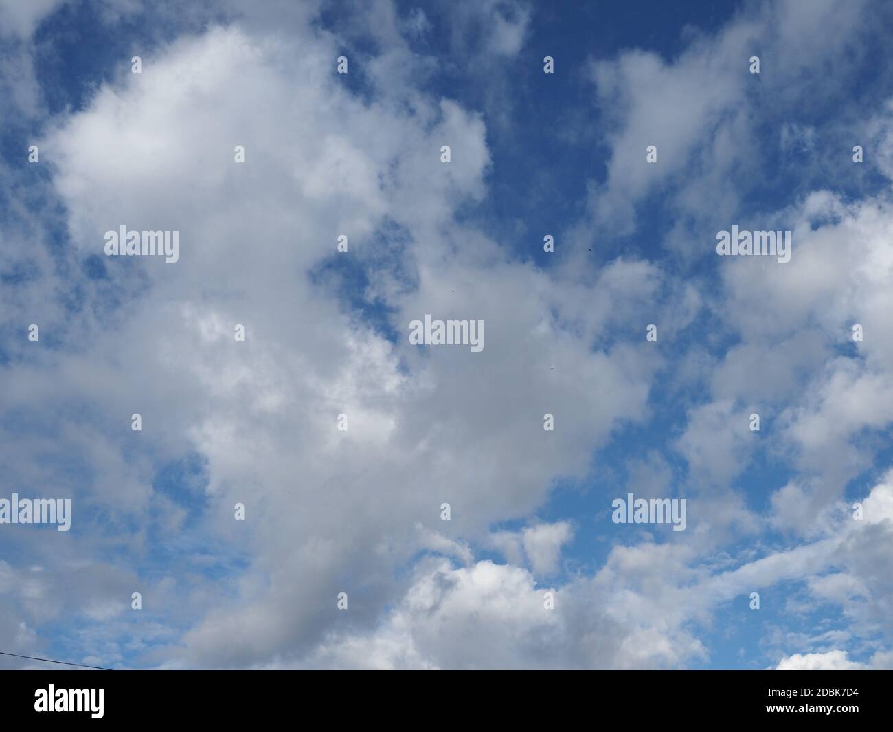 blue sky with clouds useful as a background Stock Photo - Alamy
