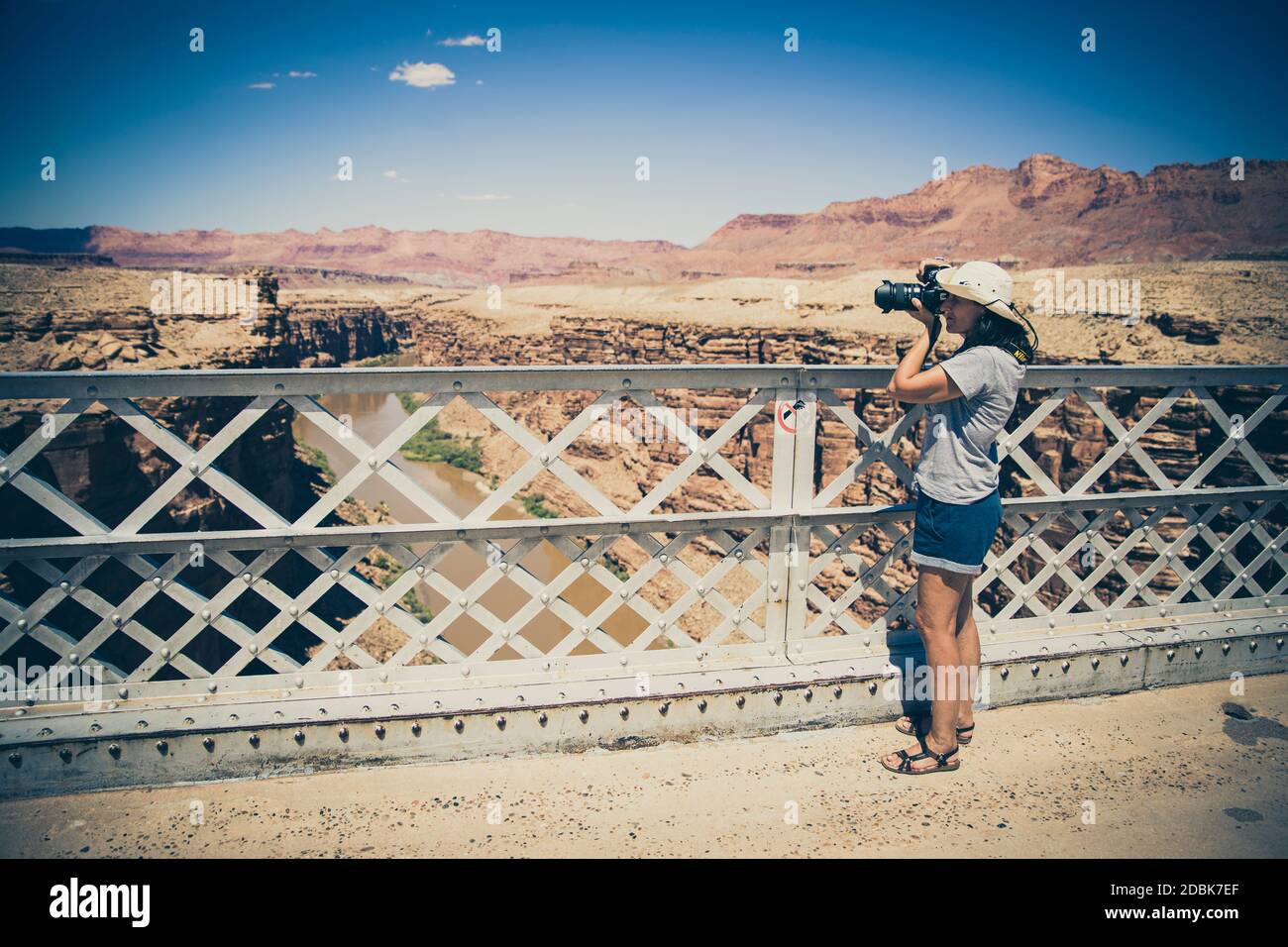 Woman photographing the Colorado River from Navajo Bridge in Marble Canyon. Arizon. USA Stock Photo