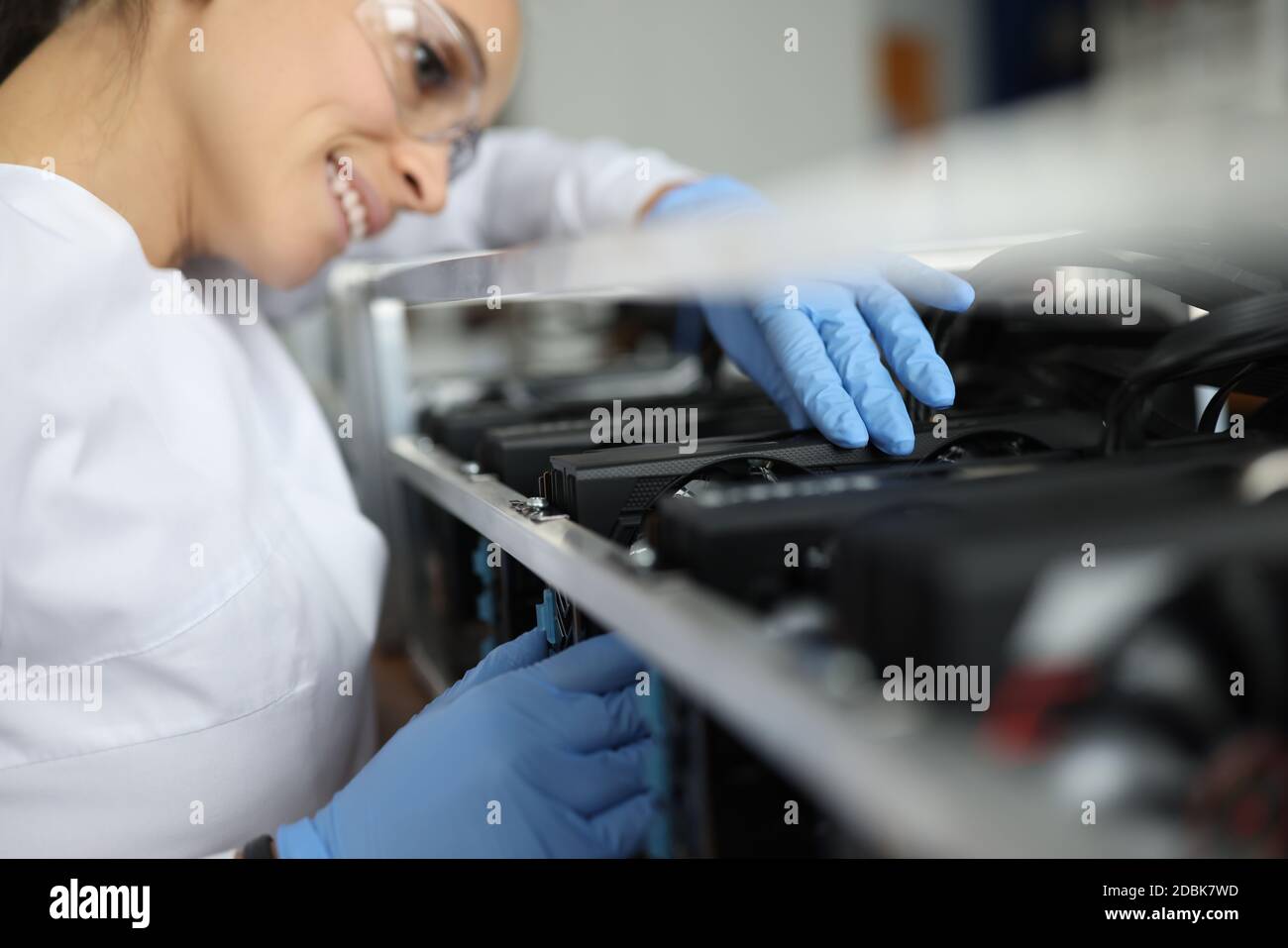 Female specialist assembling cryptocurrency mining farm closeup Stock Photo