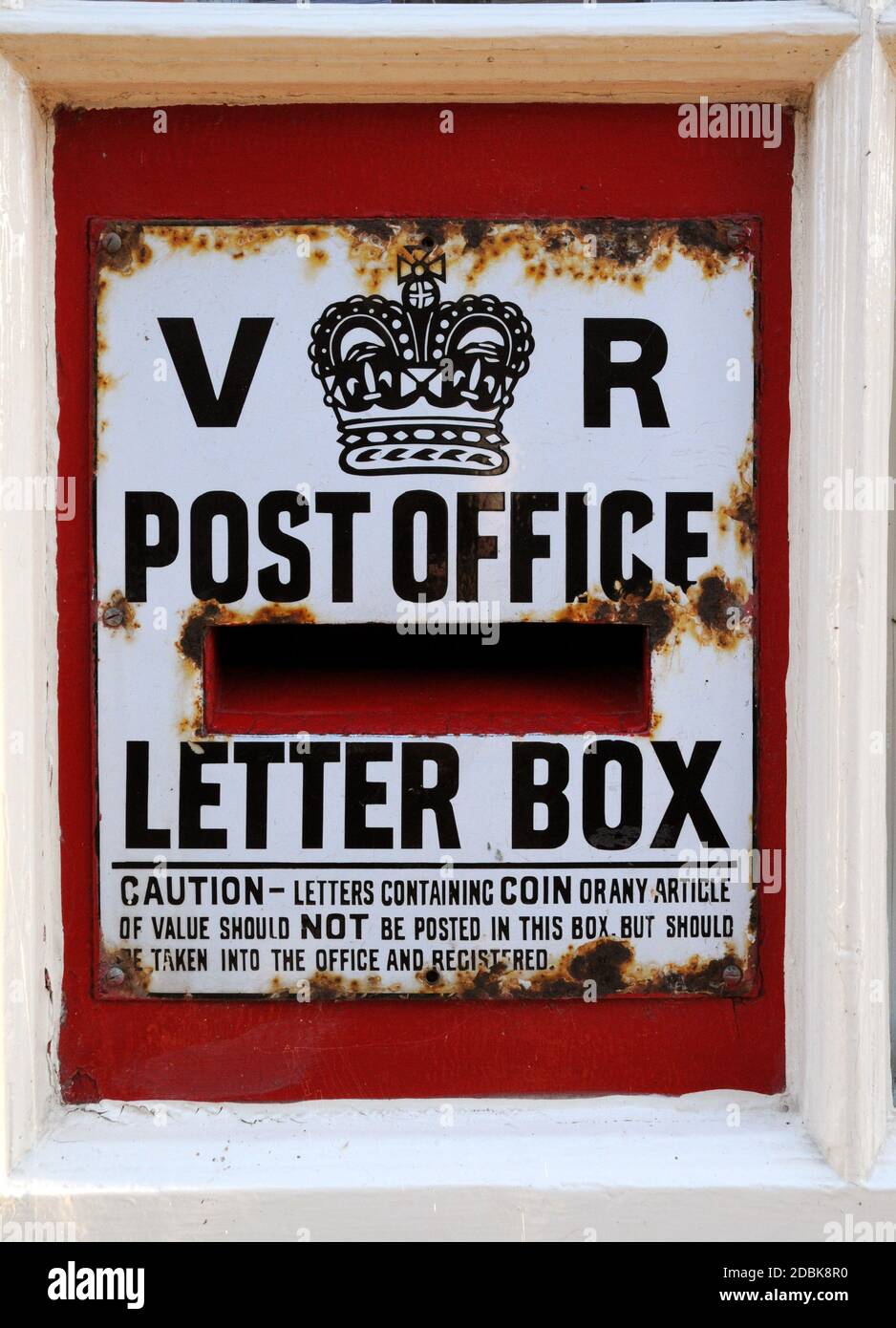 The old post box, dating from the reign of Queen Victoria, set into the wall of the village store and post office in the East Sussex village of Glynde Stock Photo