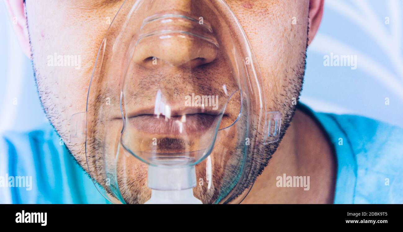 A man with an inhalation mask on his face. Stock Photo