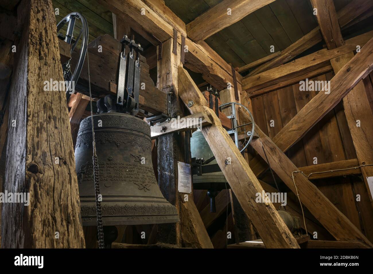 Gudow, Germany, November 13, 2020: Inside the old church tower from wooden construction with hanging bells and chiming drive mechanism in the St. Mary Stock Photo