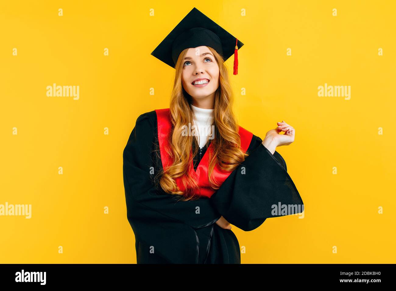 A thoughtful, attractive graduate in a master's dress, on a yellow background. Concept of the graduation ceremony Stock Photo - Alamy A thoughtful, attractive graduate in a master's dress, on a yellow background. Concept of the graduation ceremony Stock Photo - Alamy