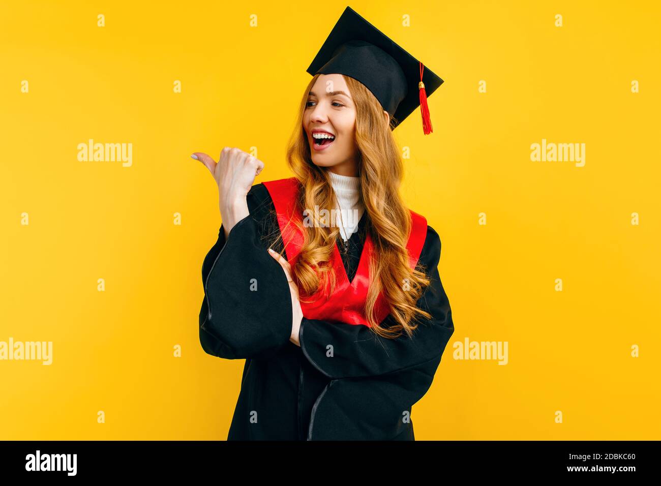 A female graduate student smiles as she points at a copy of the space ...