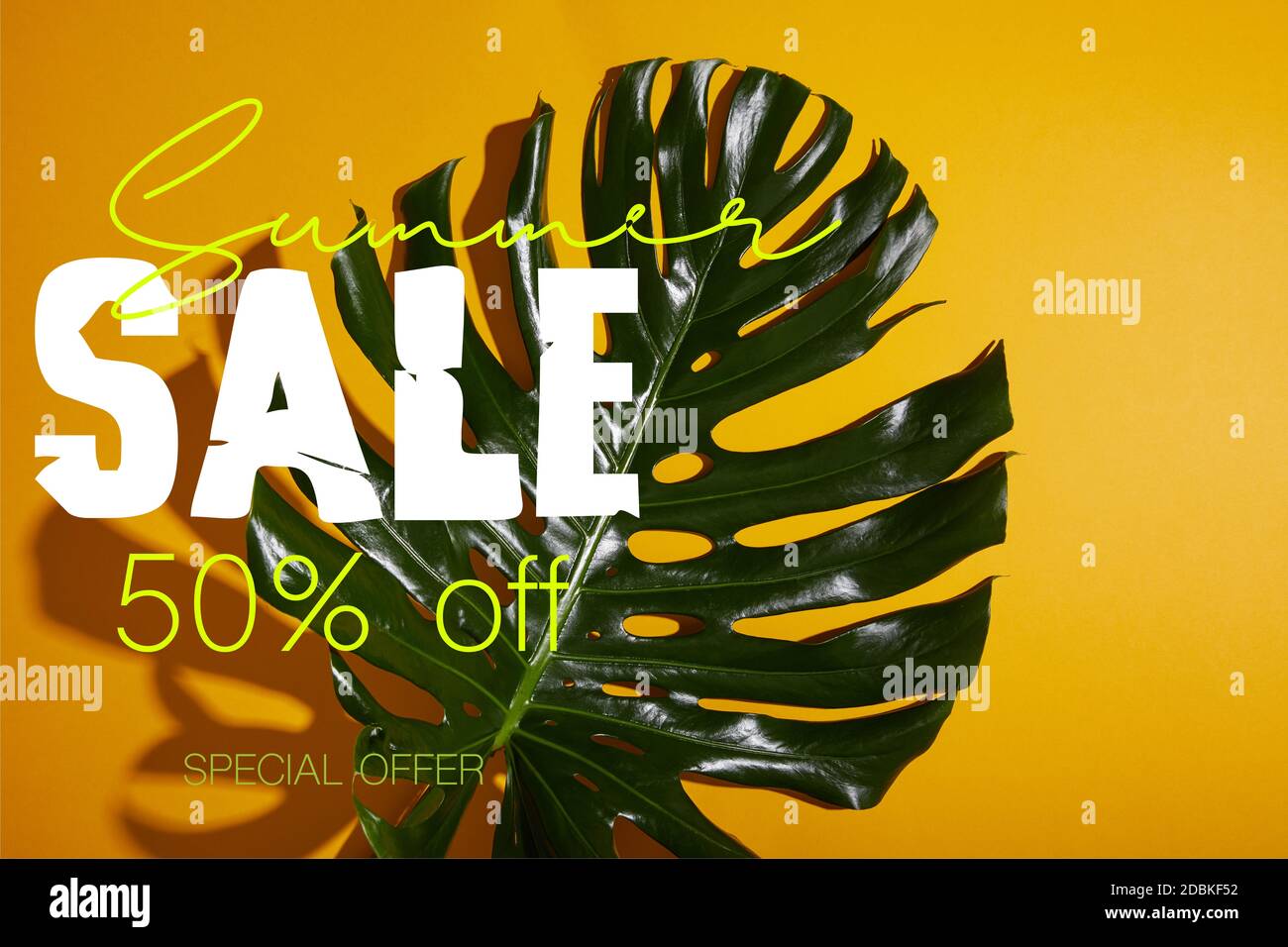 top view of tropical green leaf on yellow background with summer sale ...
