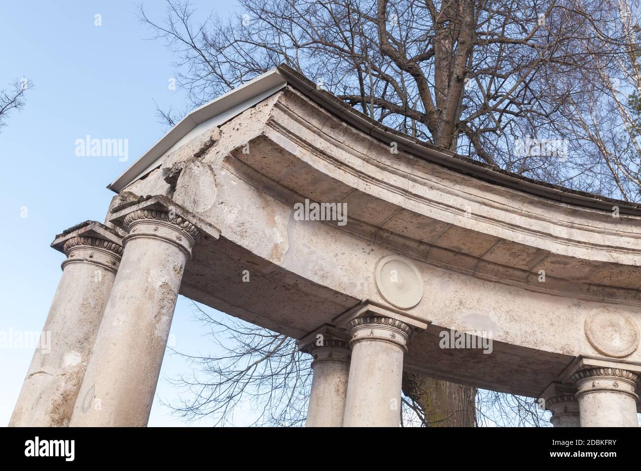 White pillars of classical portico under blue sky. Old classical