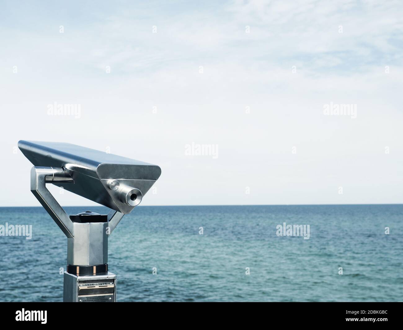 Binoculars on a pier, concept for far-sightedness or look into the future, space for text on the right Stock Photo