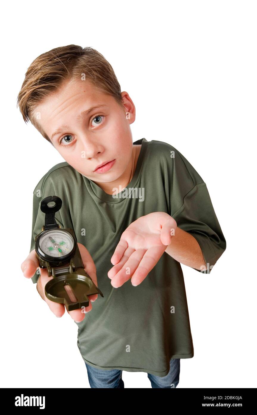 Wide-angle three-quarter view of a 12-year-old Caucasian boy with a compass on his right hand looking at the camera at a loss, isolated on white. Stock Photo
