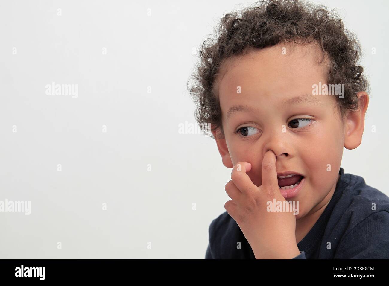 boy picking his nose with white background stock photo Stock Photo