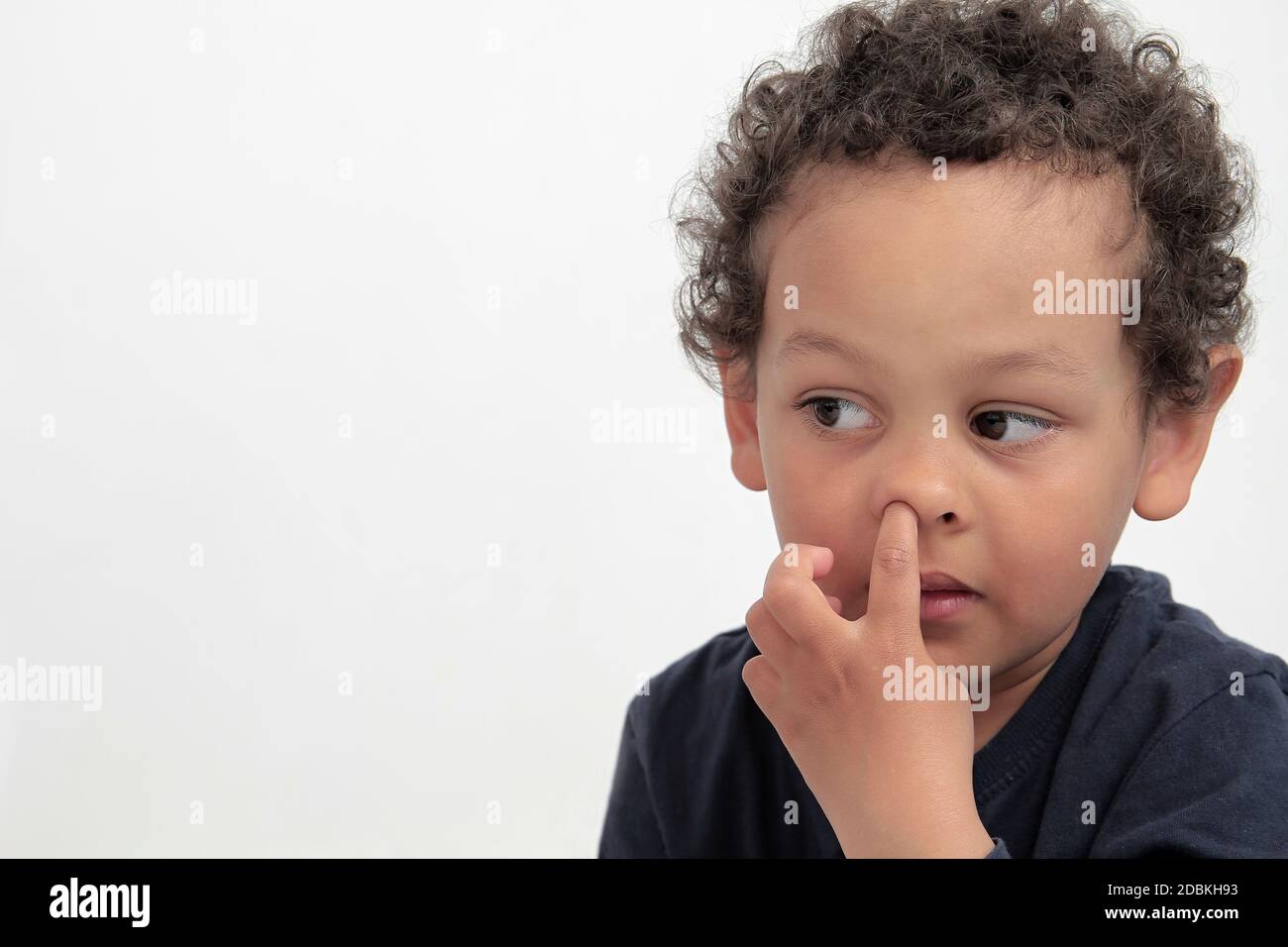 boy picking his nose with white background stock photo Stock Photo