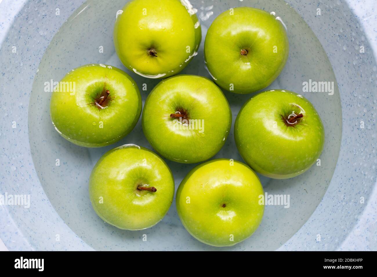 Soak green apples in water. Washing fruit concept Stock Photo Alamy