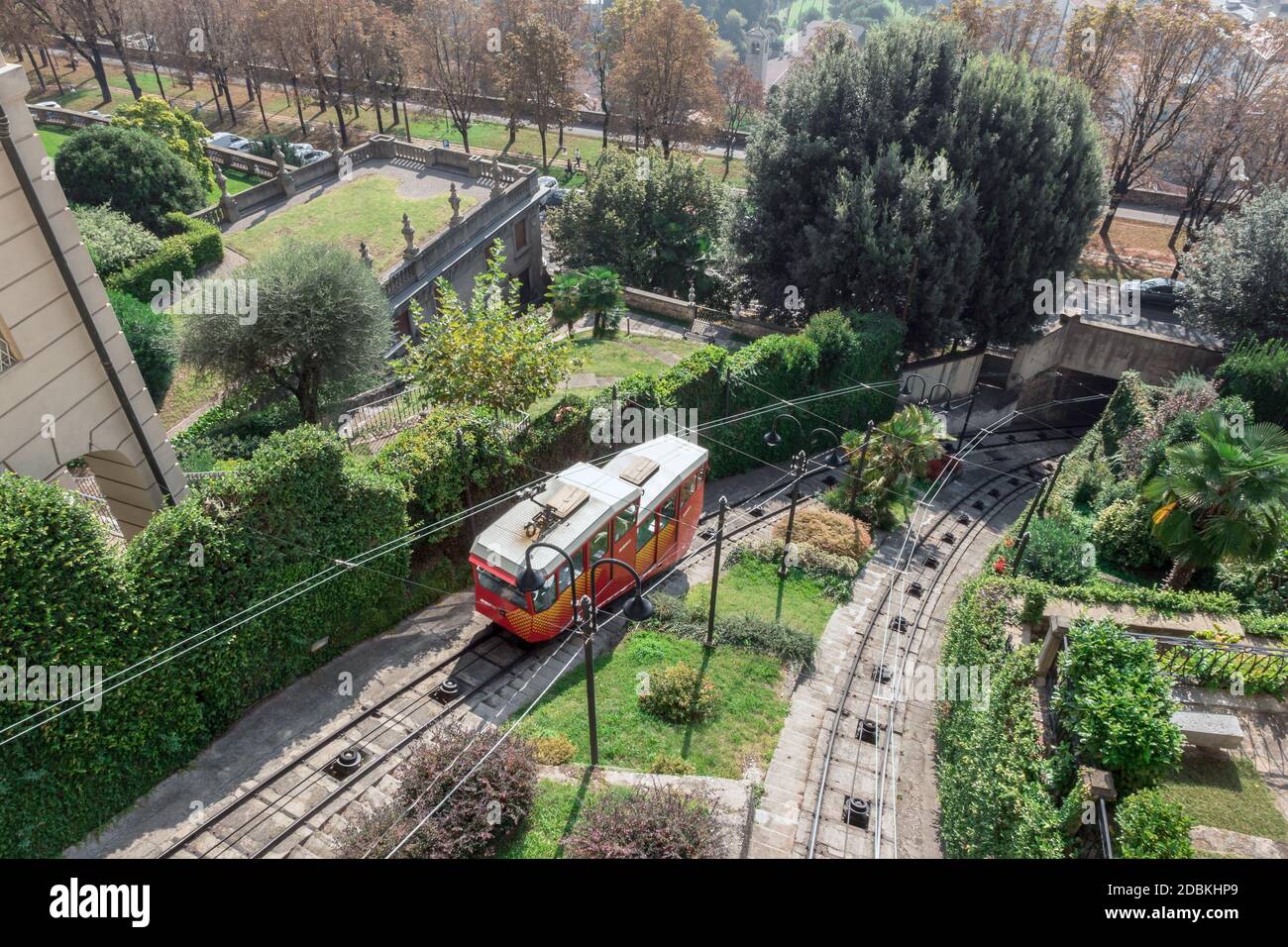 Upper city funicular line in Bergamo (Funicolare Citta Alta). Red funicular connects old Upper City and new. Scenic view of Bergamo historical center. Stock Photo