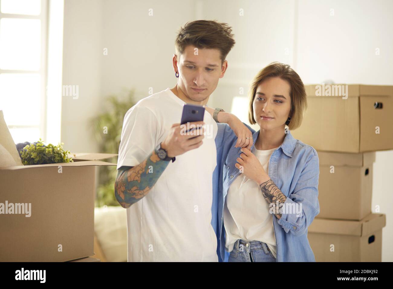 Happy smiling young couple showing a pair of keys of their new house ...