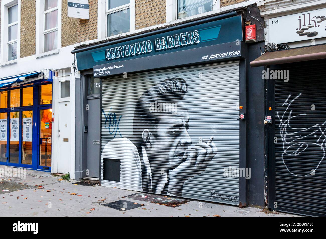 A mural on the shutters of Greyhound Barbers on Junction Road, Archway, closed during the second coronavirus pandemic lockdown, London, UK Stock Photo
