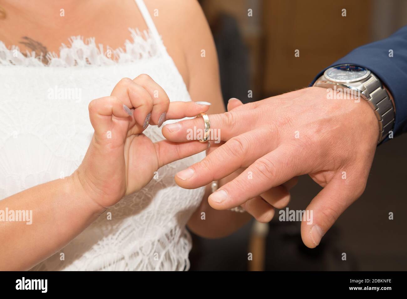 The bridal couple exchanges the wedding rings with each other Stock Photo