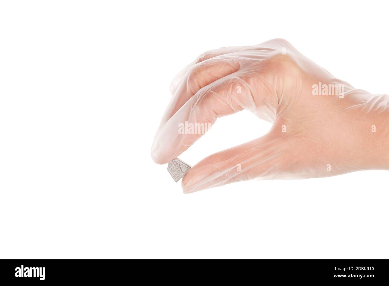 Ecstasy pill in doctor hand with disposable vinyl gloves isolated on white background. MDMA therapeutical use. Stock Photo