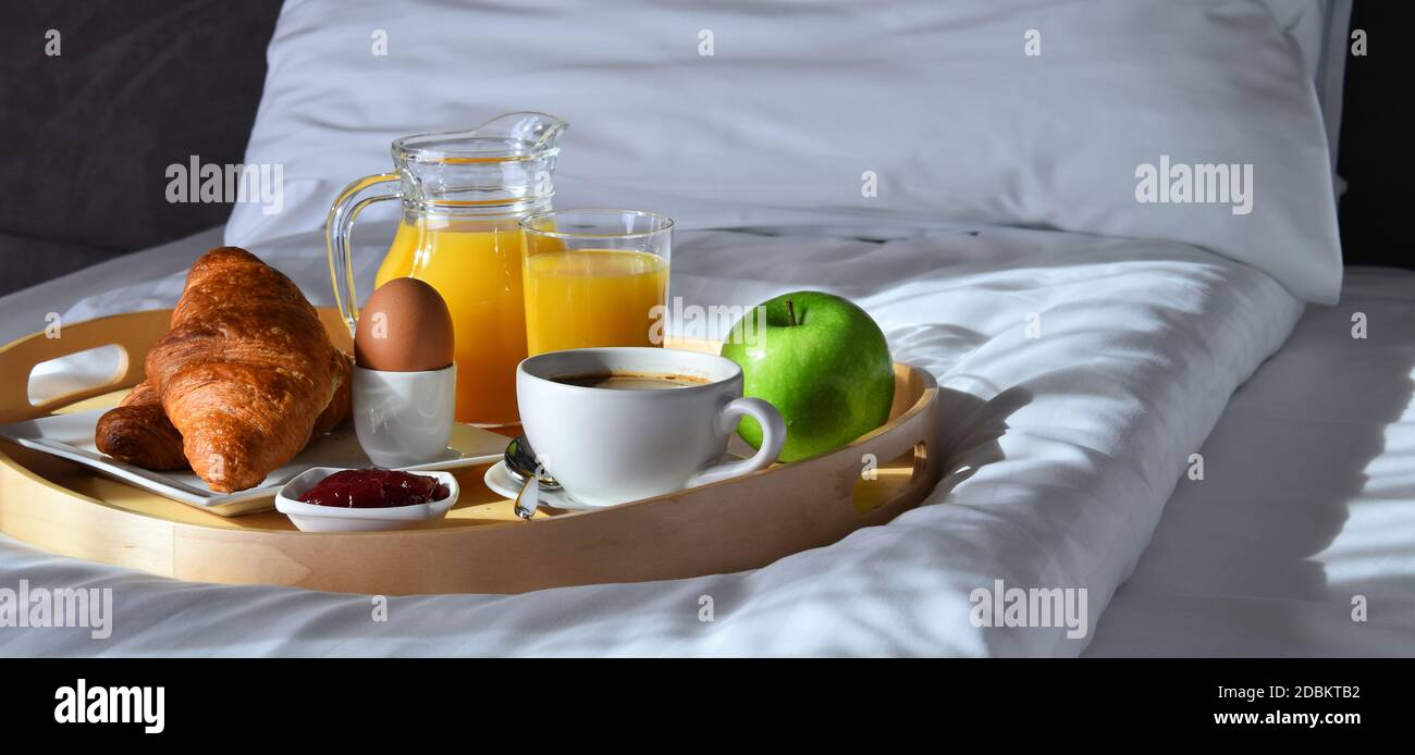 Breakfast on tray in bed in hotel room Stock Photo - Alamy