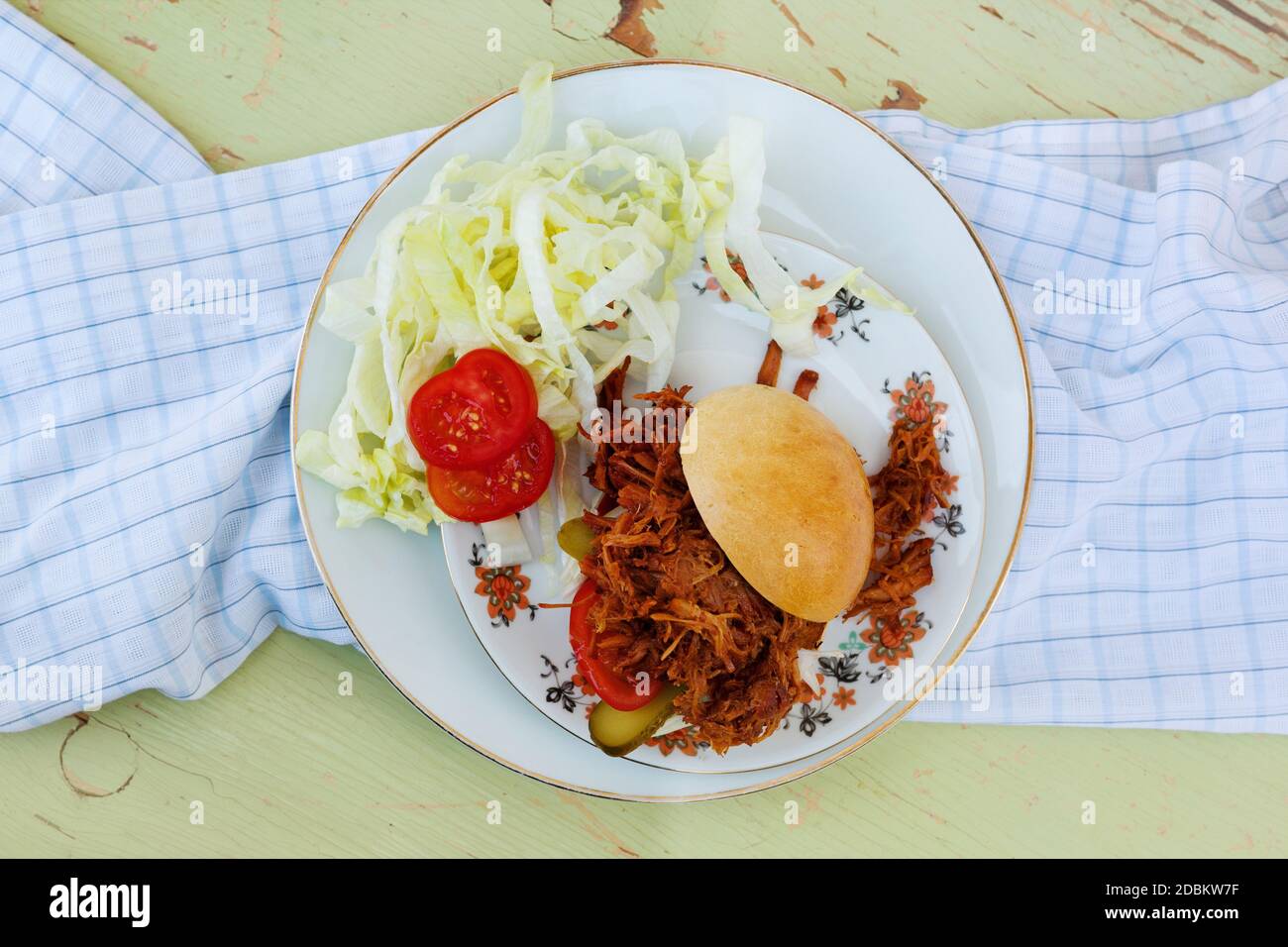 Pulled pork burger on plate in sunny day from above. Party food background. Stock Photo