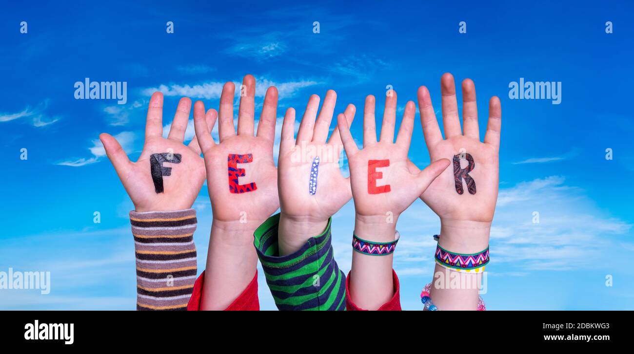 Children Hands Building Colorful German Word Feier Means Celebration. Blue Sky As Background Stock Photo