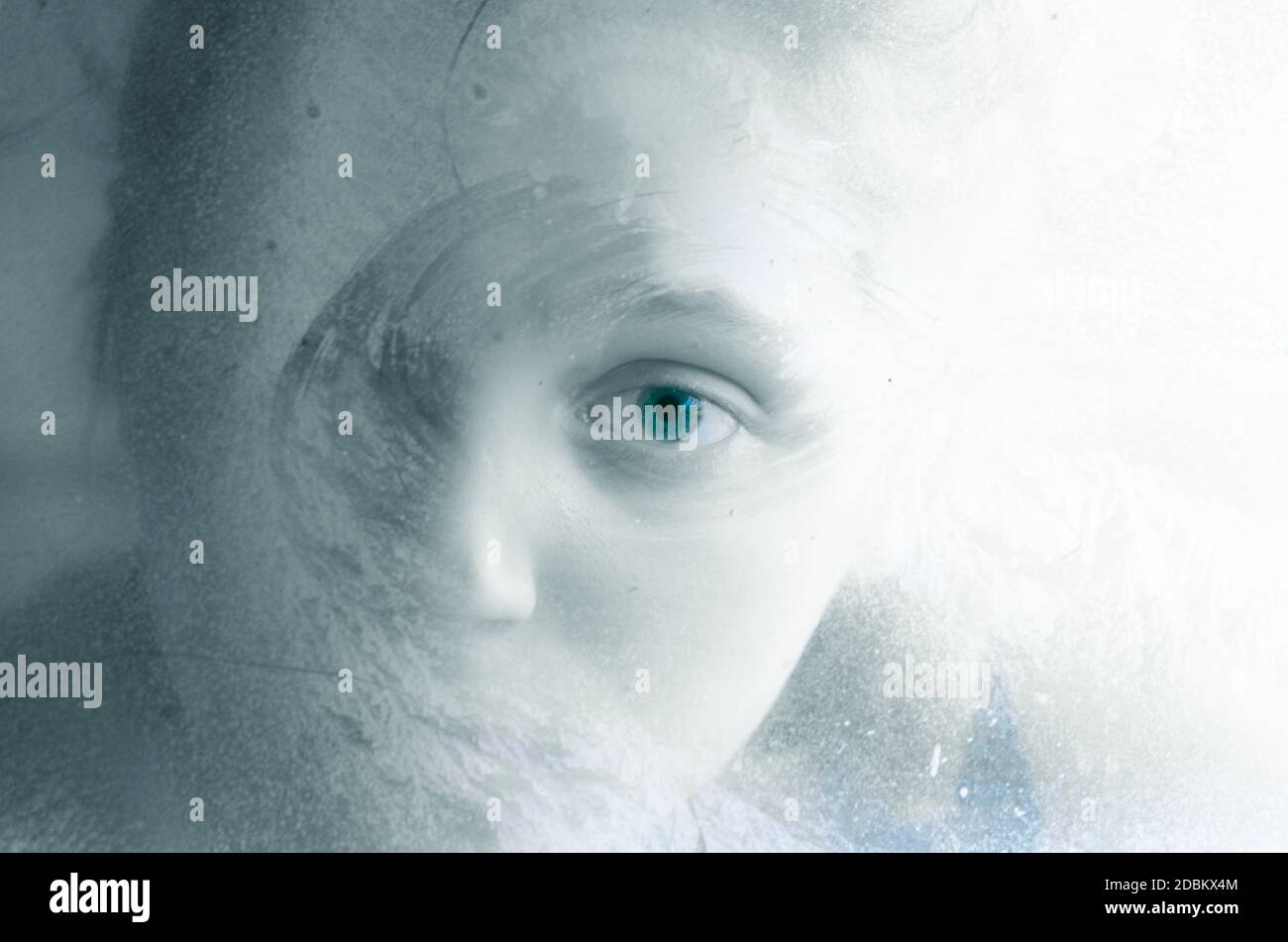 adorable little child face looking through frosty icy window experiment Stock Photo