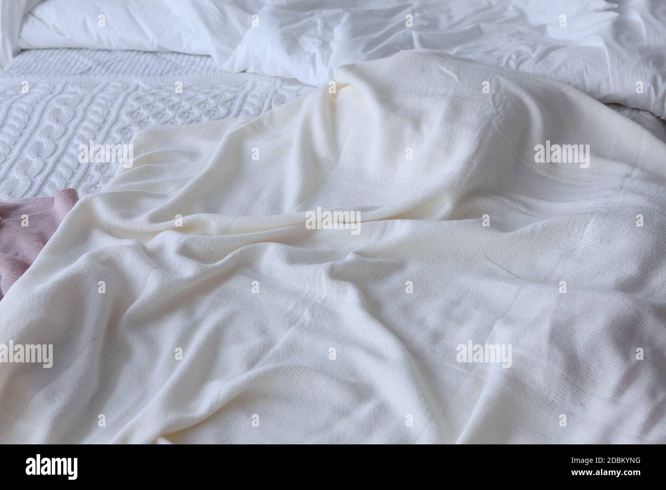 A rumpled bed. An unmade bed with bedspreads.Mess in the bedroom. Top ...