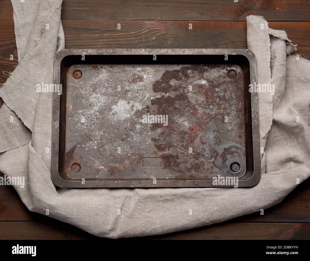 empty rectangular iron rusty baking sheet on a wooden brown table, top view Stock Photo